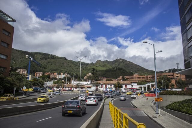cars-road-city-against-sky-scaled